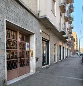 a row of buildings with doors on a street at Casa Filadelfia in Turin