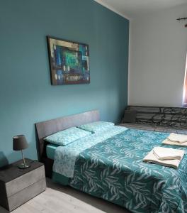 a bedroom with a bed and a blue wall at Casa Filadelfia in Turin