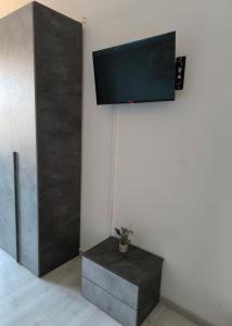 a flat screen tv hanging on a wall at Casa Filadelfia in Turin