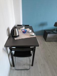 a black table with a tea kettle on top of it at Casa Filadelfia in Turin
