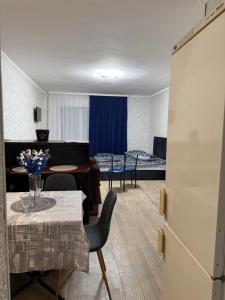 a room with a table and chairs and a bedroom at Апартамент с джакузи in Khmelnytskyi +24 photos