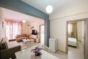 a living room with a couch and a table at Dashamiri's Villa in Sarandë