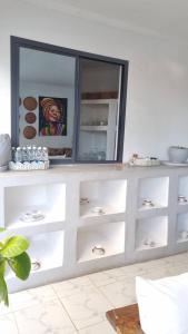 a white dresser with a mirror in a room at Terrys villa pool view room in Kidoti
