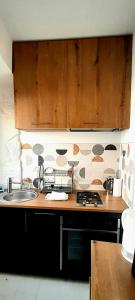 a kitchen with a sink and a counter top at Appartement quartier des Halles in Douarnenez