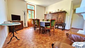a living room with a table and chairs and a couch at Ecluse Mingot in Châtillon-en-Bazois