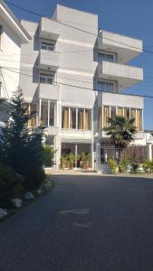 a white building with a street in front of it at North Star Hotel in Shkodër