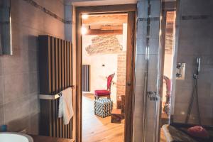 a bathroom with a shower and a red chair in a room at La Lune de Saint George in Hone +73 photos