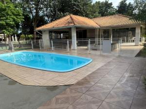 a large blue swimming pool in front of a house at Apartamento confortável in Santarém
