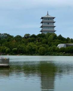 a large building in the middle of a lake at 春江屿舍 in Xi'an