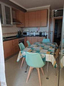a kitchen with a table and chairs and a table and a kitchen at Q1 Blueroom Sofia's Happy Apartment in Loulé