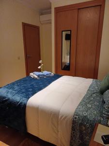 a bedroom with a large bed with towels on it at Q1 Blueroom Sofia's Happy Apartment in Loulé +1 photo
