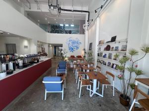 a restaurant with tables and chairs and a counter at Bubble Humble Bangkok By Canal in Bangkok