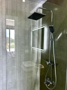 a shower with a glass door in a bathroom at Casa del jazmin Kfarabida in Kafr ‘Ubaydā