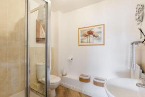 a white bathroom with a toilet and a sink at Harbourside Retreat - Spacious Balcony with Harbour Views in Poole