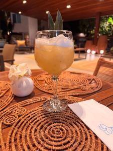 a drink in a glass sitting on a table at Pousada Lua Bela in Fernando de Noronha