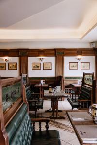 a restaurant with a couch and tables and chairs at Dabas Hotel in Dabas +193 photos