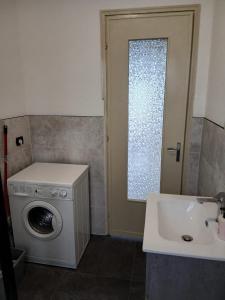 a bathroom with a washing machine and a sink at La Maison d'la Brumatera , ALLOGGIO CON 2 CAMERE DA LETTO E VISTA in Rubiana