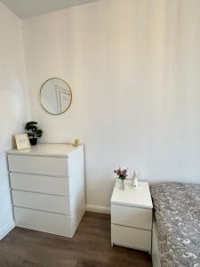 a bedroom with a bed and a mirror and a dresser at Apartments Brunsbüttel 2 in Brunsbüttel