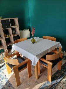 a dining room table with chairs and a vase on it at La Maison d'la Brumatera , ALLOGGIO CON 2 CAMERE DA LETTO E VISTA in Rubiana +4 photos