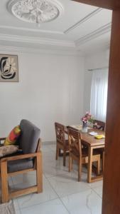a living room with a dining room table and chairs at Résidence PAYAN in Douala
