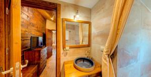 a bathroom with a tv and a tub in it at Къща за гости "Панорама" Проглед in Smolyan +34 photos