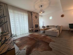 a living room with a couch and a table at Apartment A36 Silver Mountain in Poiana Brasov