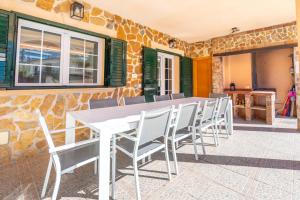 a white table and chairs on a patio at Villa Trobadors in El Arenal