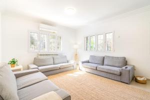 a living room with two couches and a rug at Villa Trobadors in El Arenal