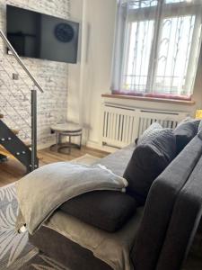 a living room with a couch with pillows on it at Pension Zur Alten Post in Havelberg
