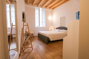 a bedroom with a bed and a ladder in it at Locanda Alberti in Mandello del Lario