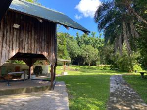 a pavilion in a park with a palm tree at Bellevue Guest Lodge in Southbroom
