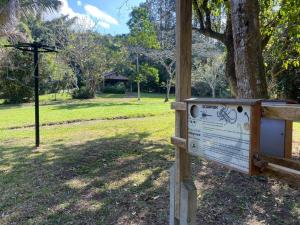 a sign in a park next to a tree at Bellevue Guest Lodge in Southbroom