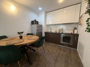 a kitchen with a table and chairs and a refrigerator at Apartment A36 Silver Mountain in Poiana Brasov
