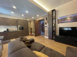 a living room with a couch and a flat screen tv at Home Dreams in Cosenza