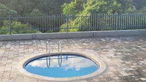 a small pool of water in the middle of a patio at Casa Baraúnas 05 in Gravatá
