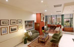 a living room with a couch and chairs and a table at Agriani Hotel - Xanthi Pool & Mountain Views in Xanthi