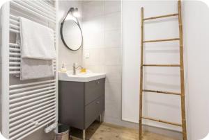 a bathroom with a sink and a mirror at L’Orée des Vignes in Saint-Sulpice-de-Faleyrens +5 photos