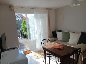 a living room with a table and a couch at La ferme de Manon in Montferrat