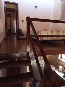 a room with two bunk beds and a staircase at Duplex 400 meters from Peró Beach in Cabo Frio