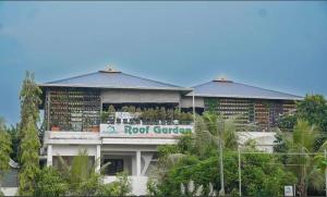 a building with a root garden sign on it at Ashiyana Homes in Nedumbassery