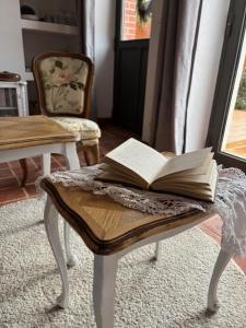 an open book on a table with a chair at chez Thérèse in Auxonne