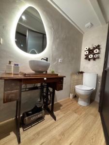 a bathroom with a sink and a toilet at chez Thérèse in Auxonne +16 photos