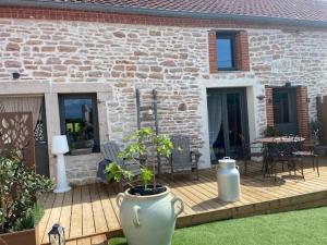 a patio with two large vases in front of a building at chez Thérèse in Auxonne