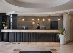 a lobby of a hotel with a reception counter at The Herbert Eilat - All inclusive Plus in Eilat +25 photos