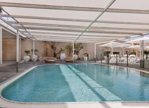 an indoor swimming pool with at The Herbert Eilat - All inclusive Plus in Eilat