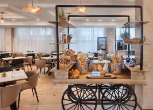 a restaurant with a table with bread on it at The Herbert Eilat - All inclusive Plus in Eilat