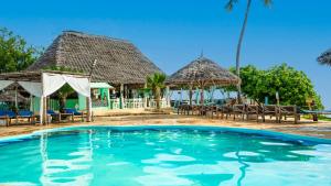 a swimming pool in front of a resort at Reef & Beach Resort - Spa Jambiani in Jambiani