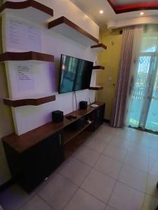 a living room with a tv and a desk at Kariba 8 in Mombasa