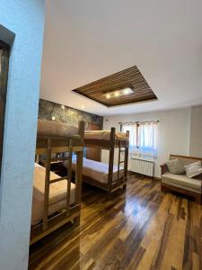 a room with two bunk beds and a couch at Casa Nuna in Tilcara