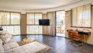 a living room with a couch and a table at The Herbert Eilat - All inclusive Plus in Eilat